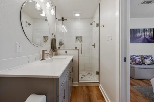 a bathroom with a sink a toilet and a mirror