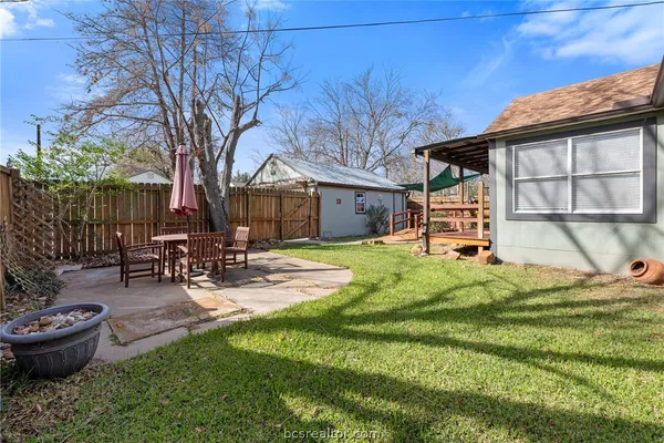 a view of a house with backyard porch and sitting area