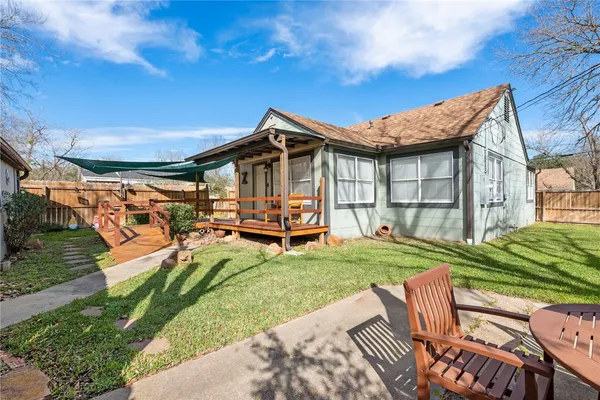 a view of a house with backyard porch and sitting area