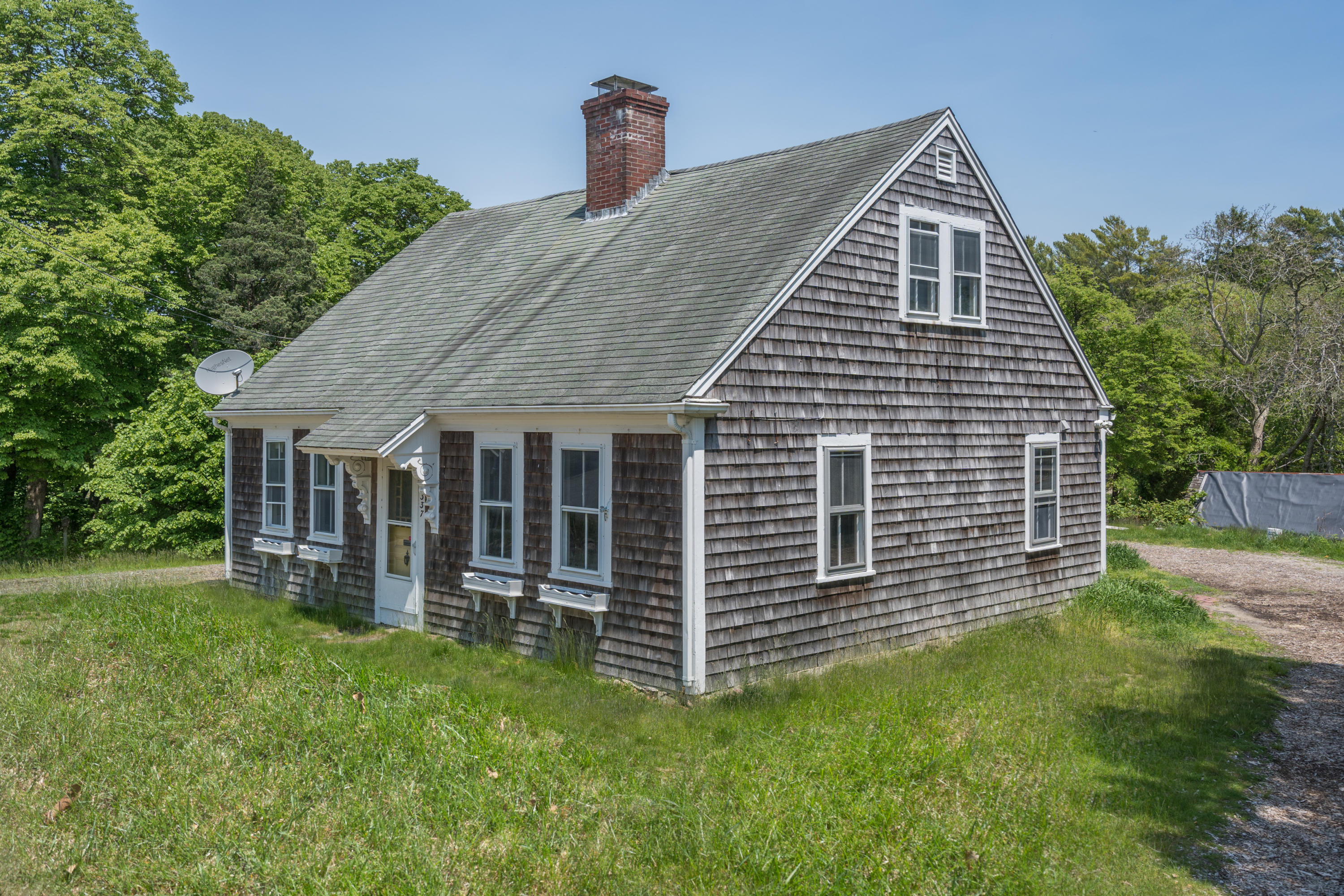337 South Main Street Centerville, MA 02632 - Photo 1 of 19 a front view of a house with a yard
