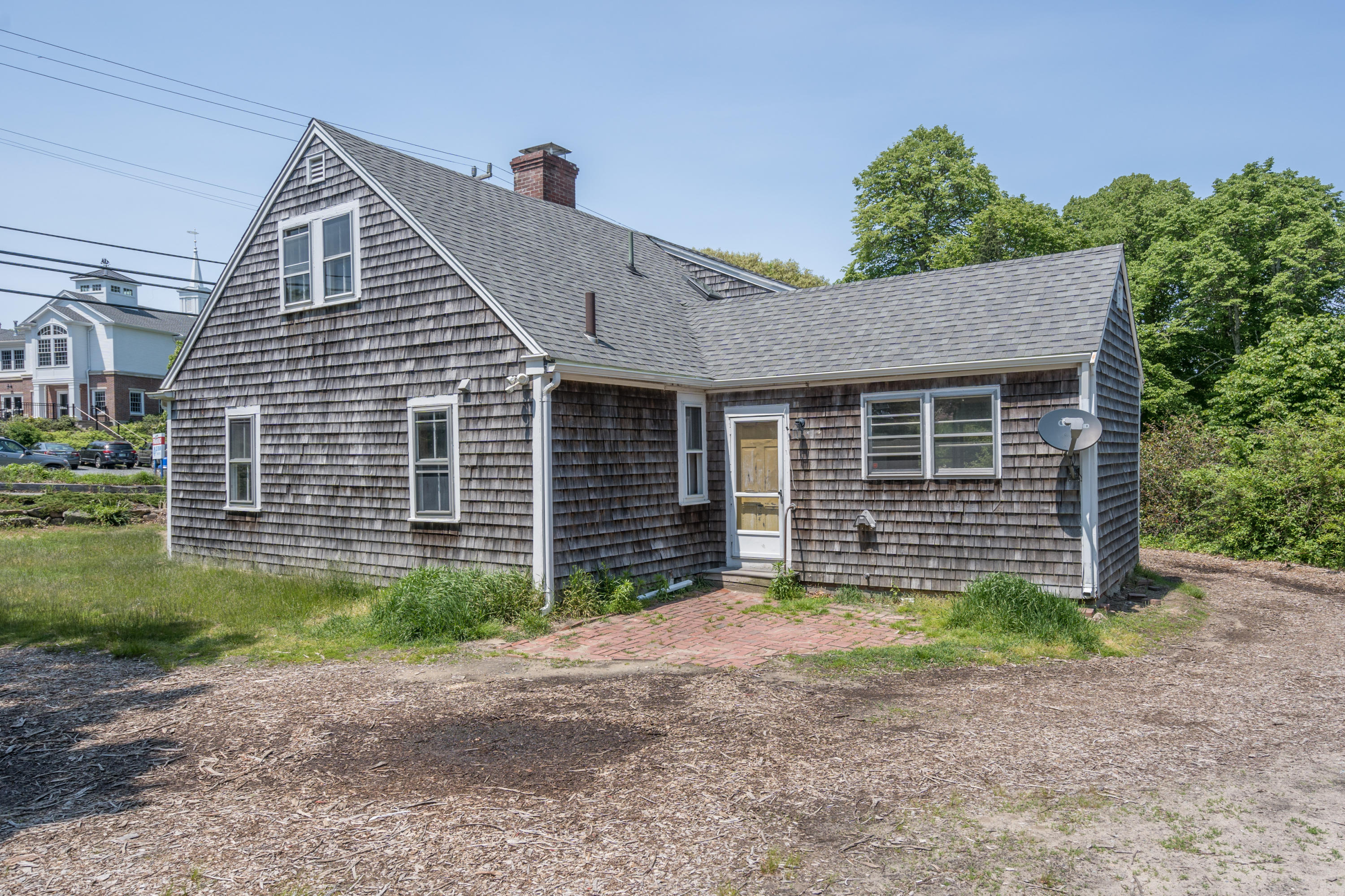 337 South Main Street Centerville, MA 02632 - Photo 17 of 19 a front view of a house with a yard and garage