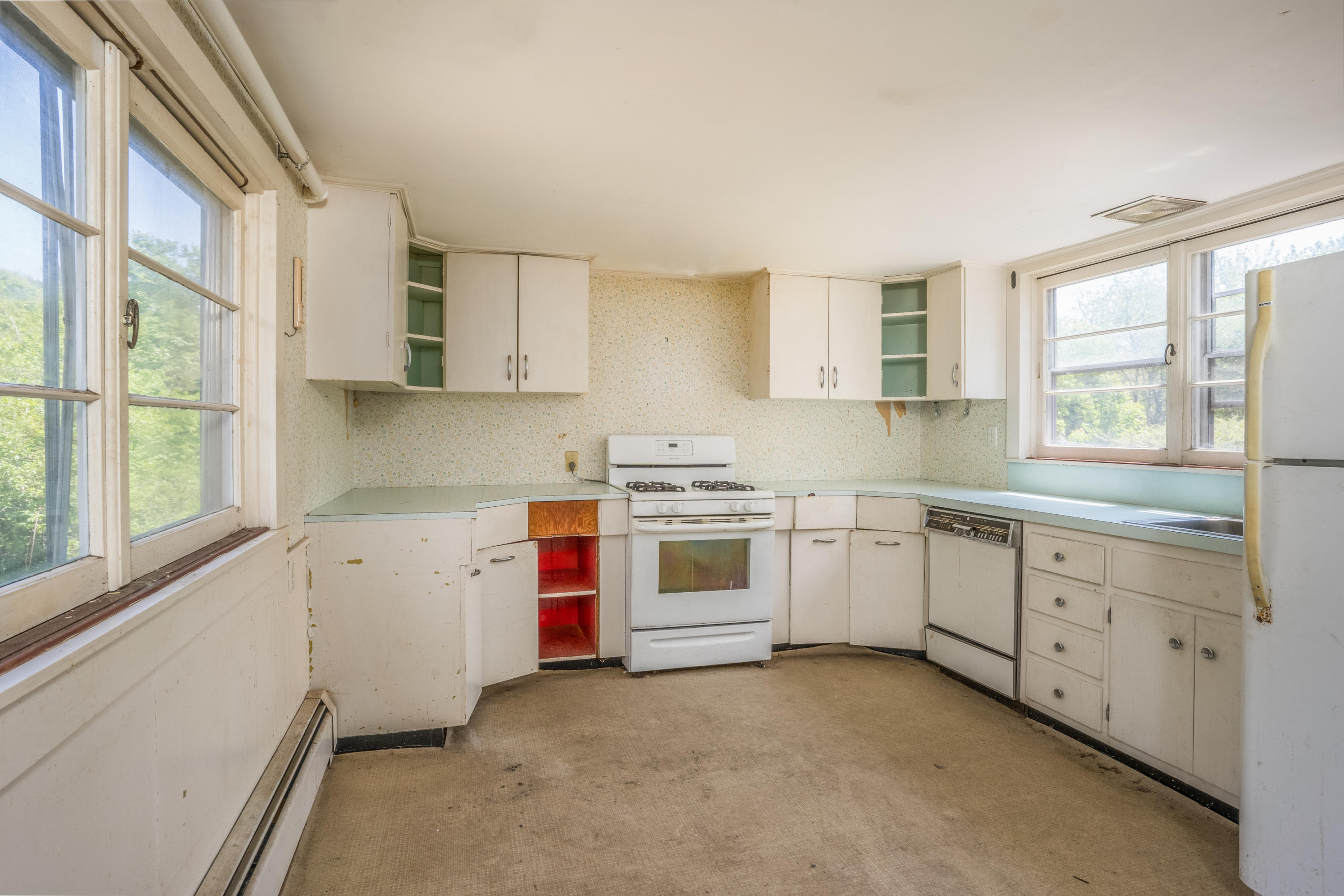 337 South Main Street Centerville, MA 02632 - Photo 5 of 19 a kitchen with granite countertop white cabinets and white appliances