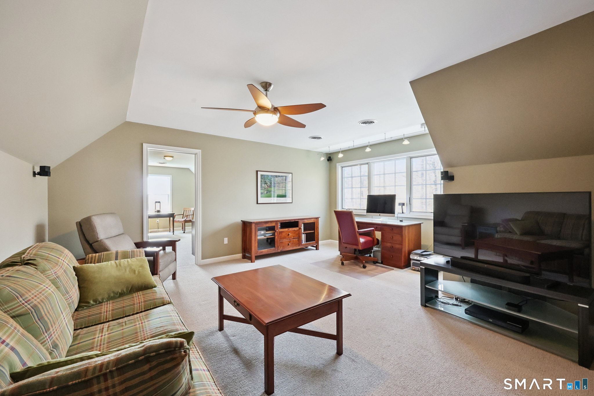 15 Mains Way Preston, CT 06365 - Photo 22 of 40 a living room with furniture a flat screen tv and a fireplace