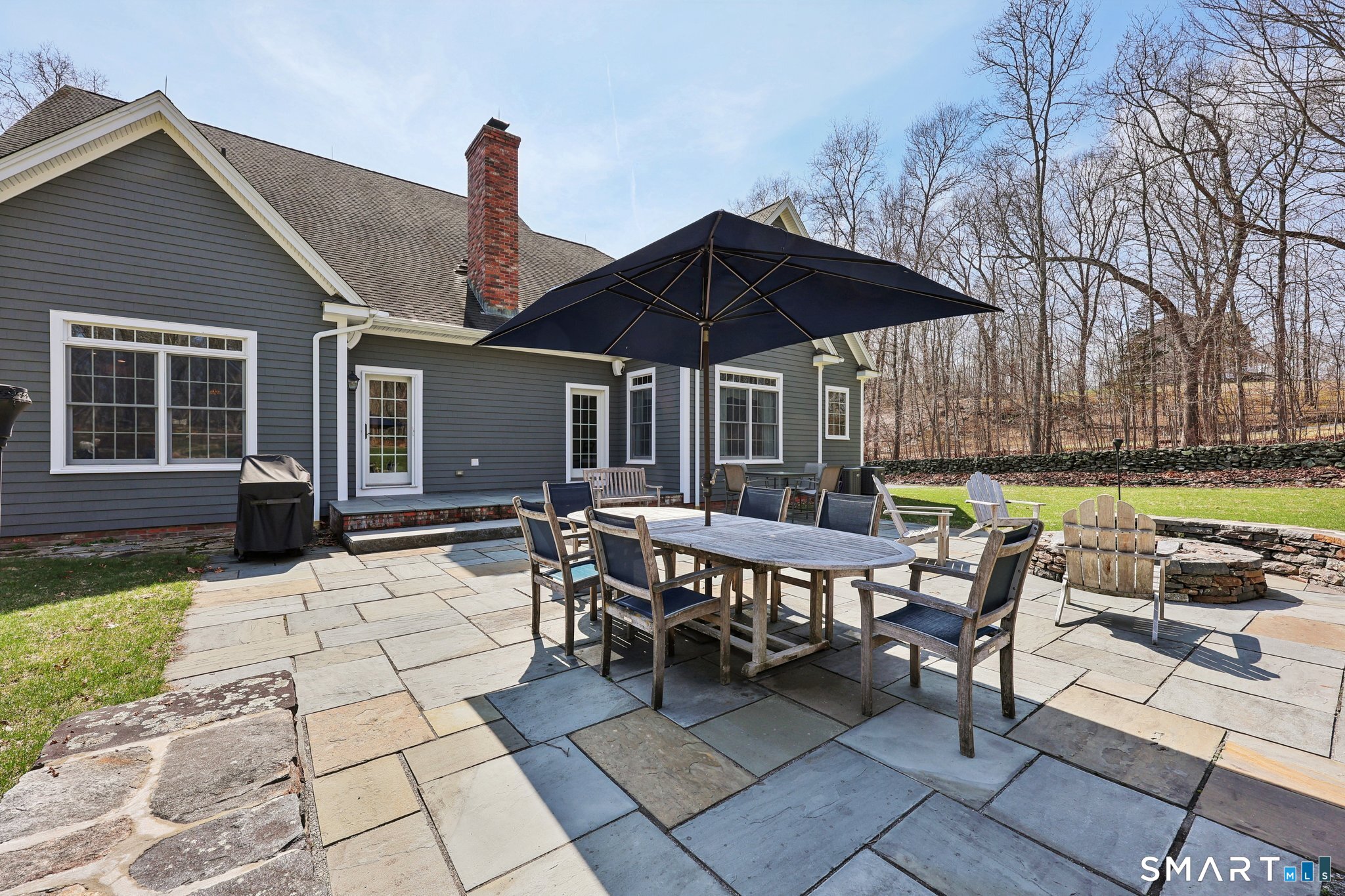 15 Mains Way Preston, CT 06365 - Photo 30 of 40 a patio table and chairs under an umbrella