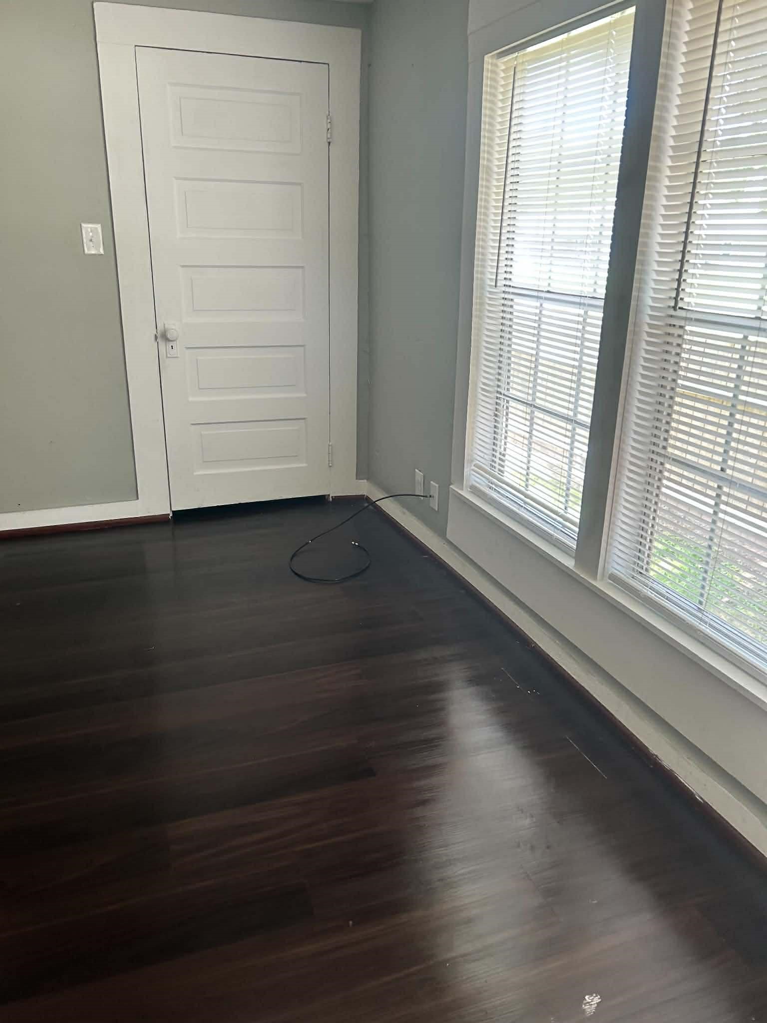 11 Smith Street Shepherd, TX 77371 - Photo 30 of 31 an empty room with wooden floor cabinet and windows