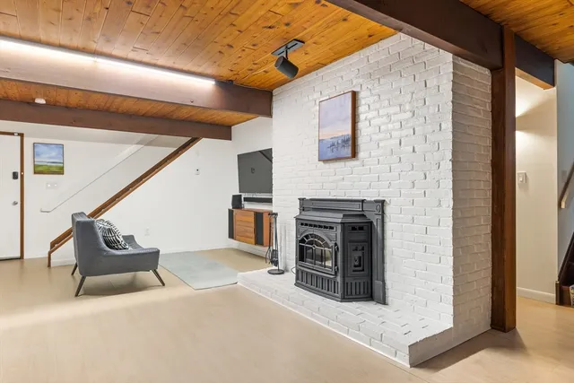 a view of a livingroom with an empty space and a fireplace