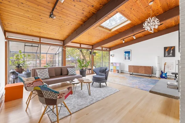 a living room with furniture a fireplace and a large window