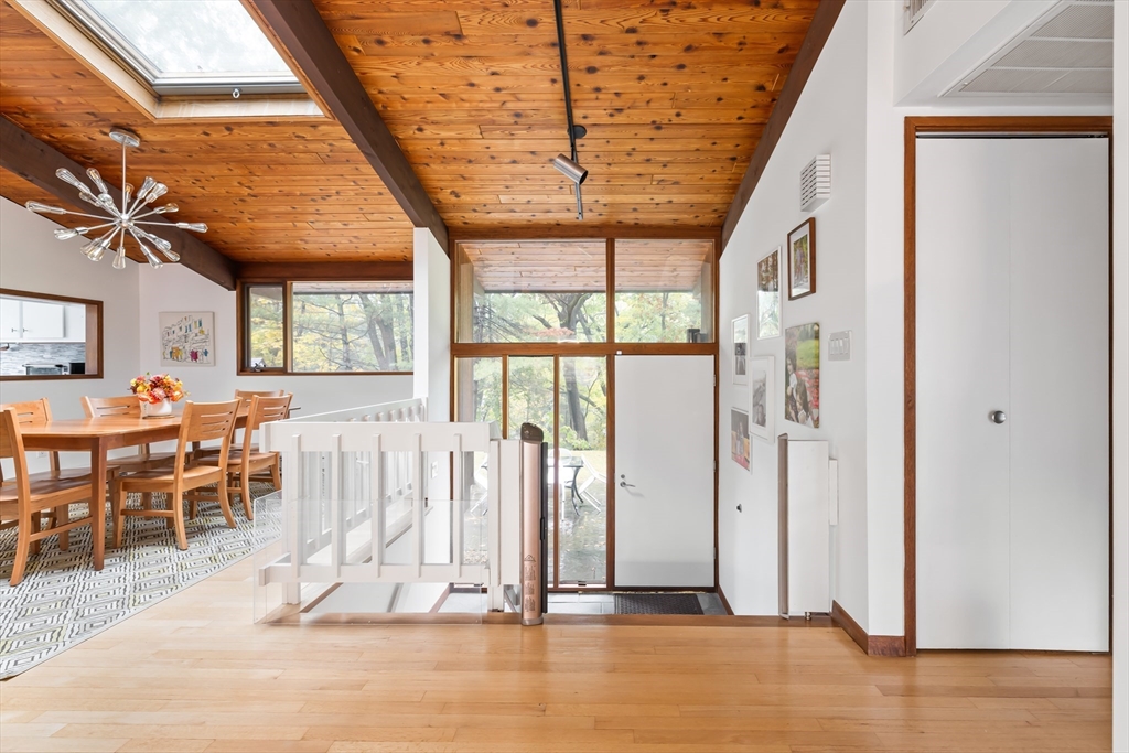 134 Rangeley Road Brookline, MA 02467 - Photo 7 of 20 a view of dining room with wooden floor and windows