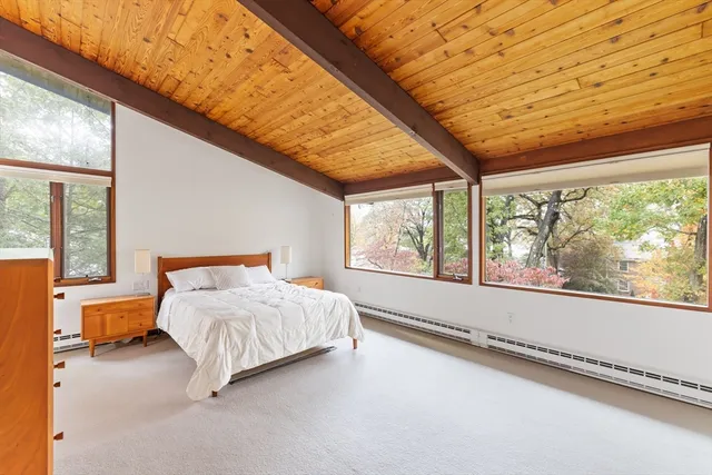 a bedroom with a bed and large window