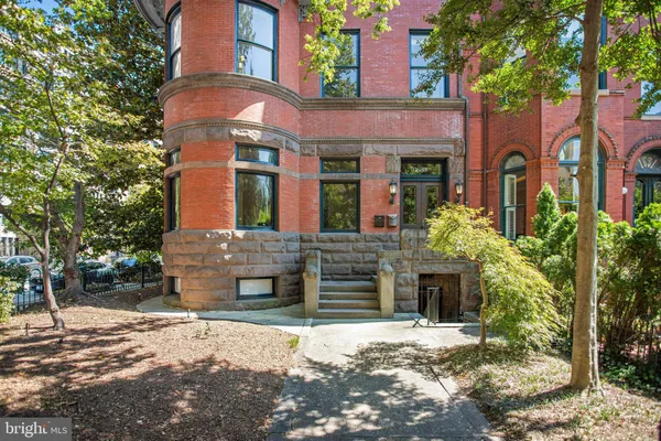 a view of a hallway view with wooden floor and staircase