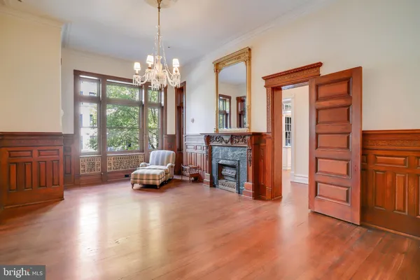 a view of empty room with wooden floor and window