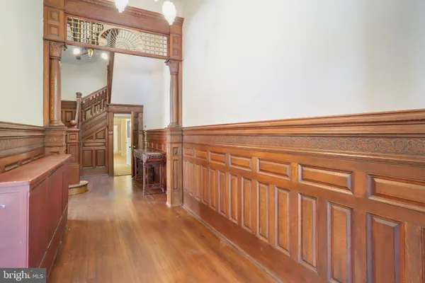 a view of a livingroom with a fireplace wooden floor and a chandelier