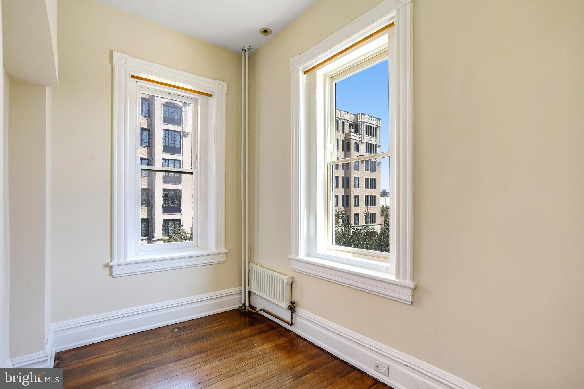 1633 16th Street Northwest Washington, DC 20009 - Photo 79 of 130 a view of an empty room with wooden floor and a window