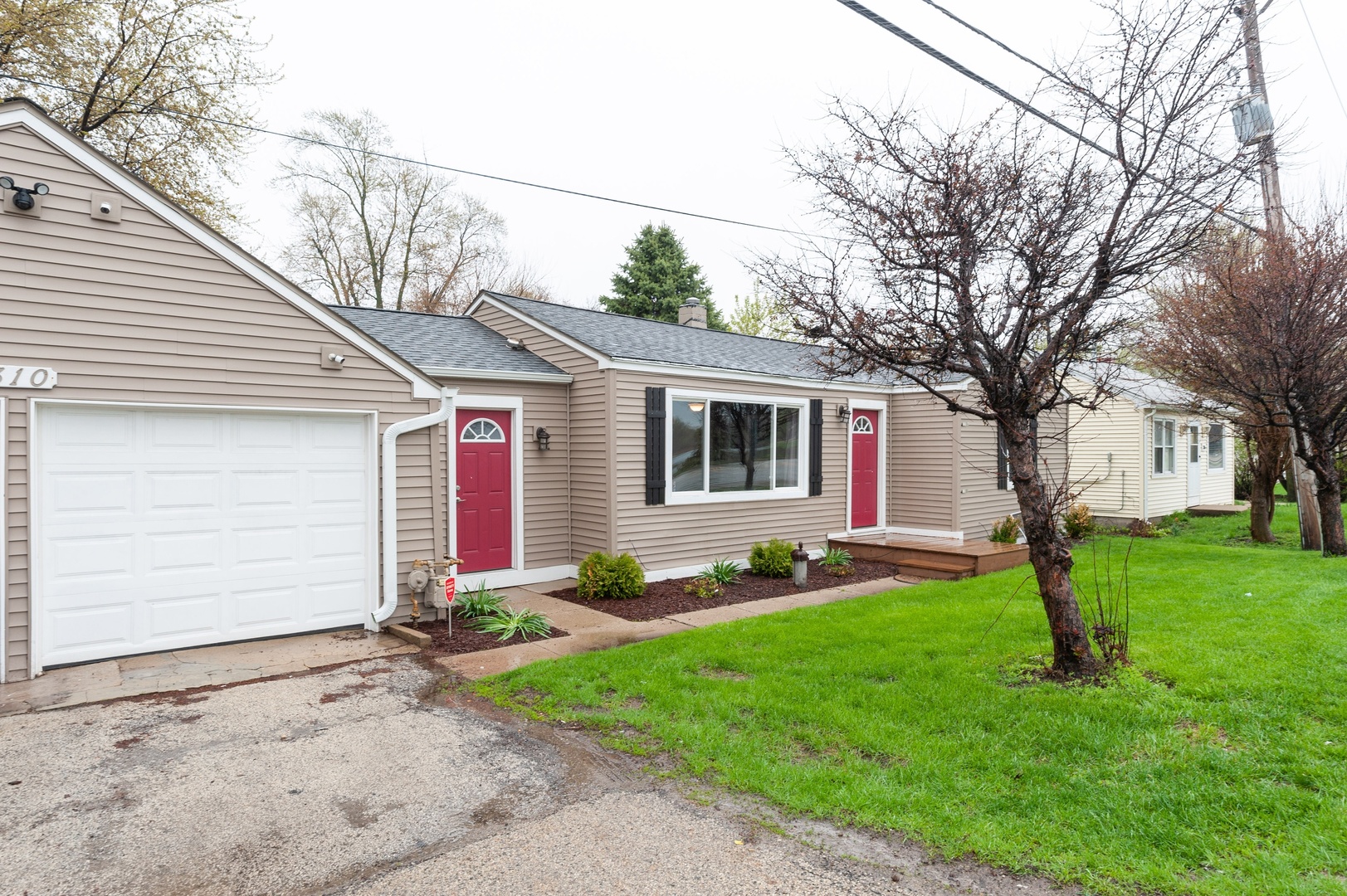 a front view of house with yard and green space