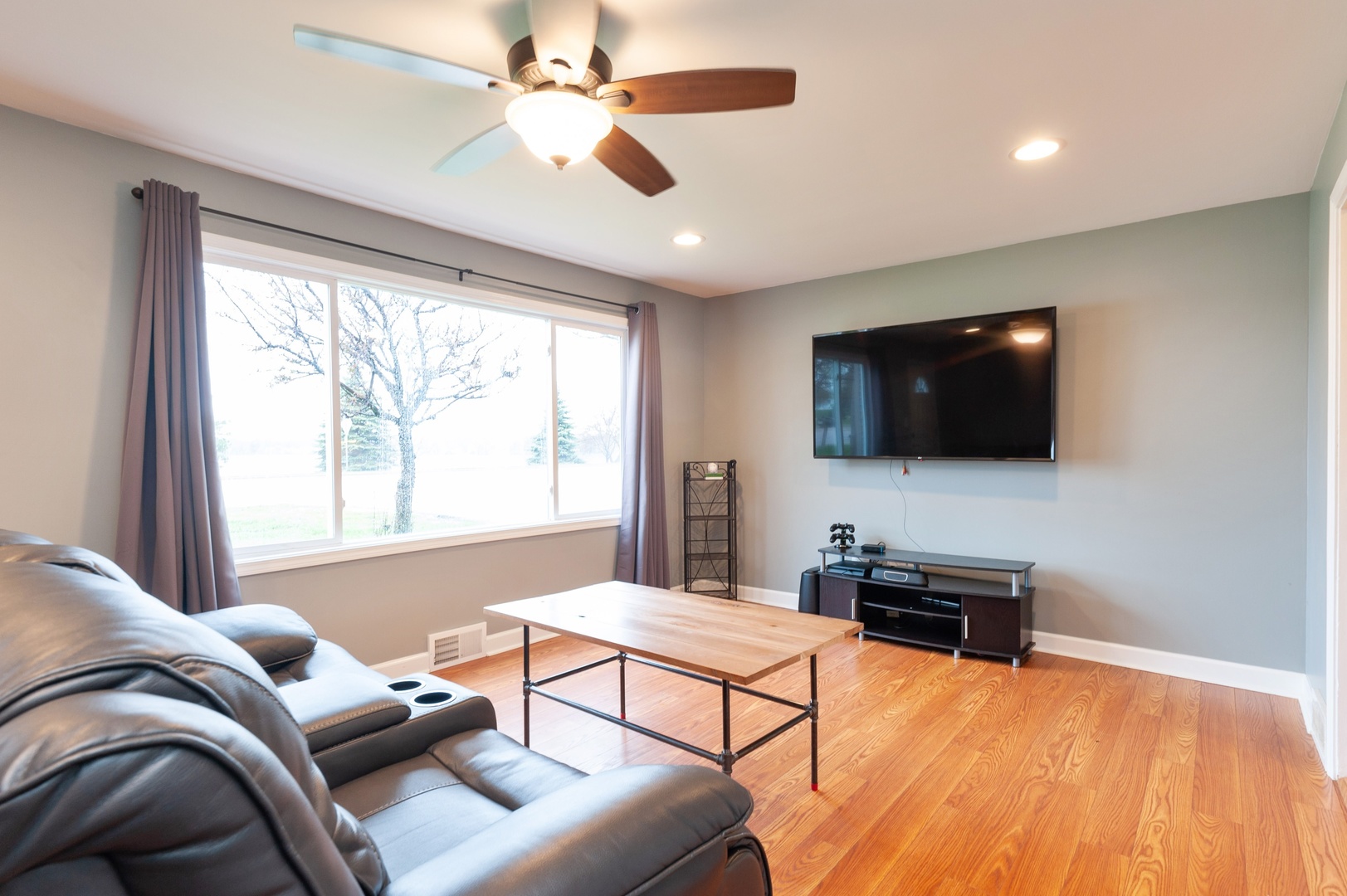 310 Rand Road Lakemoor, IL 60051 - Photo 2 of 10 a living room with furniture and a flat screen tv
