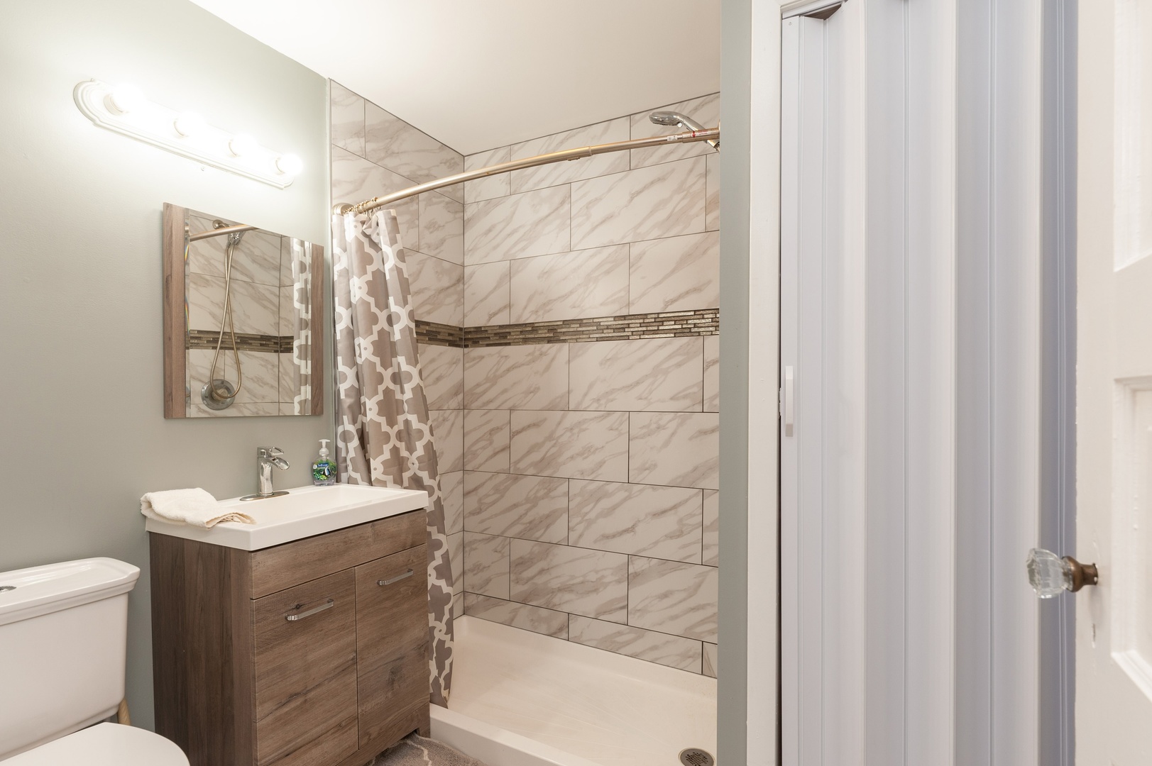 310 Rand Road Lakemoor, IL 60051 - Photo 8 of 10 a bathroom with a sink toilet and shower