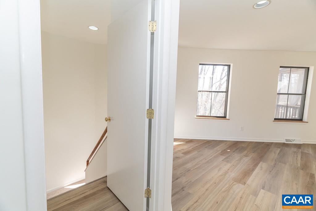 751 Exton Court Charlottesville, VA 22901 - Photo 14 of 42 a view of an empty room with wooden floor and a window