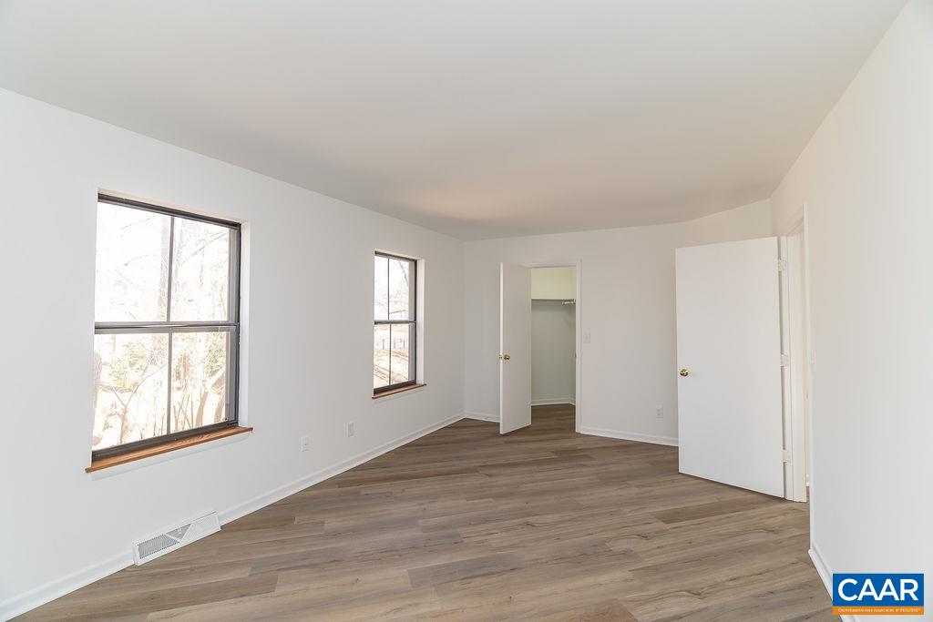751 Exton Court Charlottesville, VA 22901 - Photo 22 of 42 an empty room with wooden floor and windows