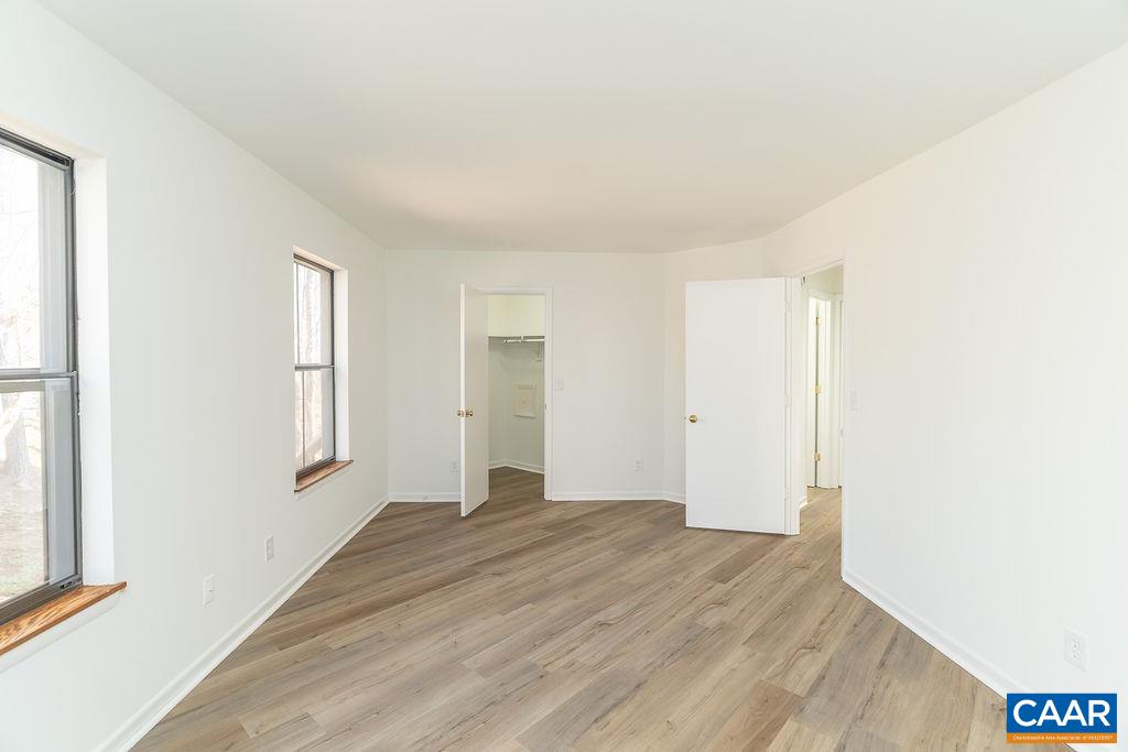 751 Exton Court Charlottesville, VA 22901 - Photo 23 of 42 a view of an empty room with wooden floor and a window