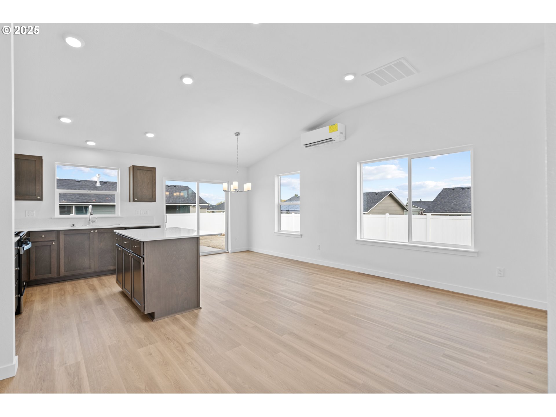 144 Southwest Eagle Drive Boardman, OR 97818 - Photo 4 of 22 a view of kitchen with stainless steel appliances kitchen island wooden floors and living room view