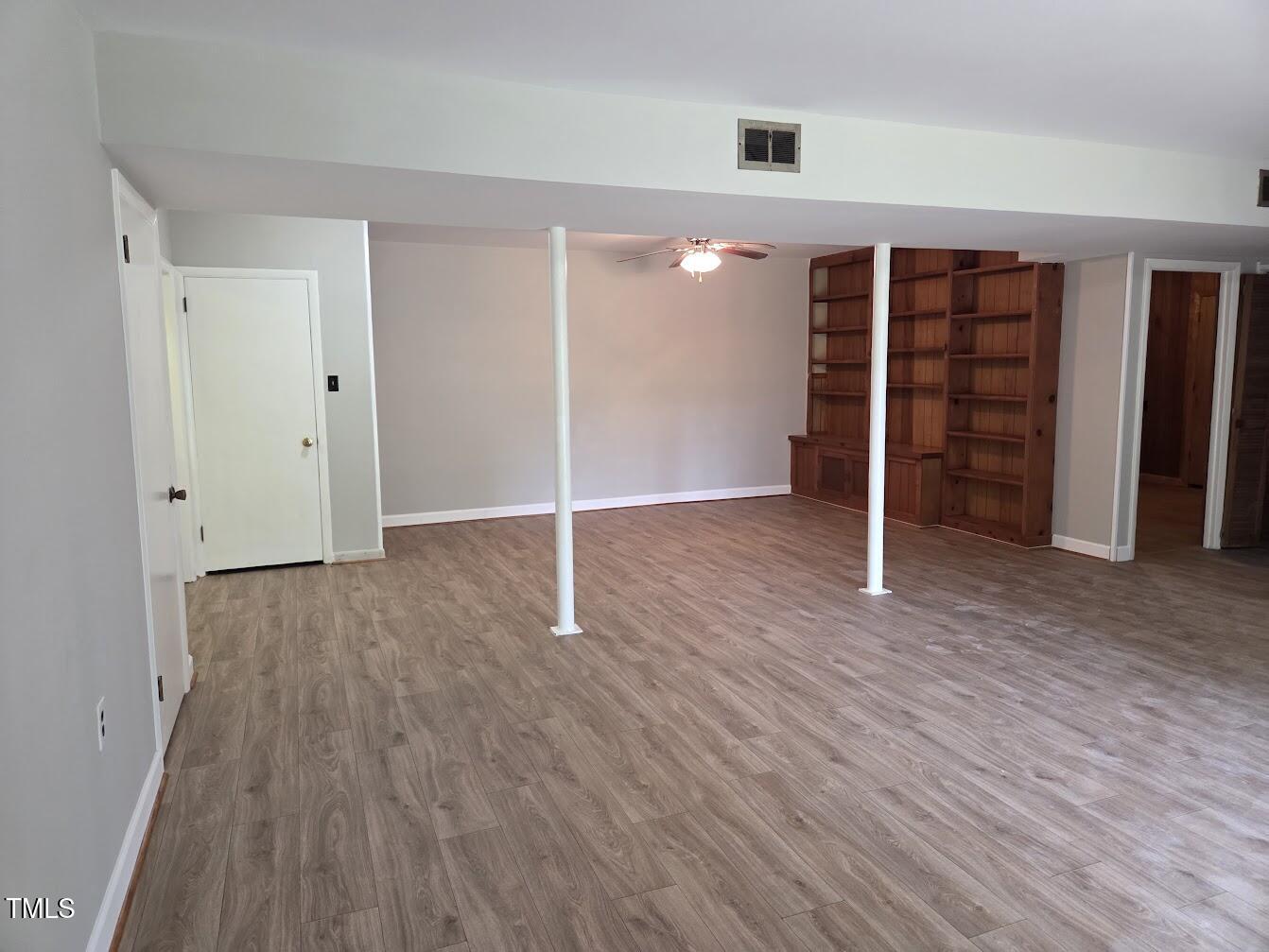 4116 Jane Lane Raleigh, NC 27604 - Photo 21 of 25 an empty room with walk in closet with wooden floor