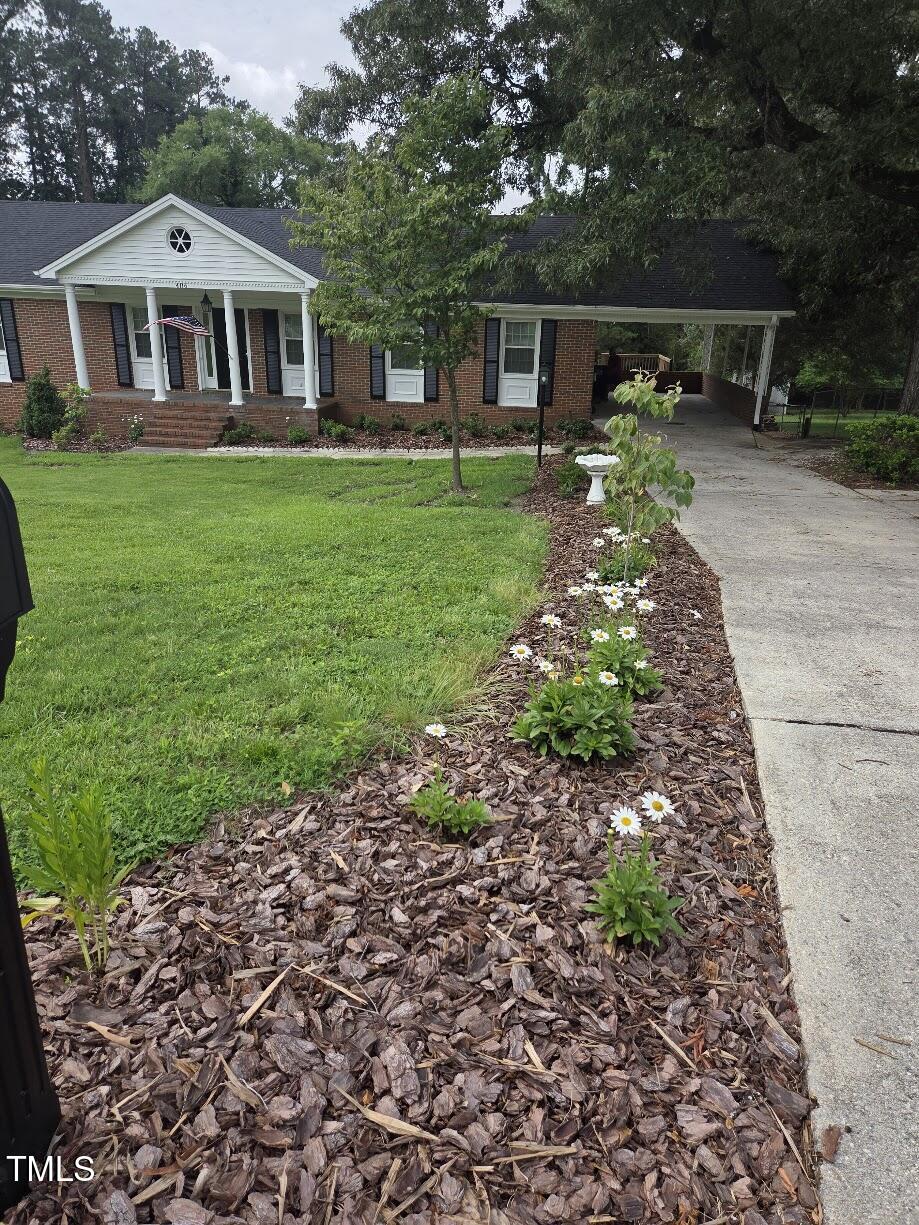 4116 Jane Lane Raleigh, NC 27604 - Photo 3 of 25 a front view of a house with garden