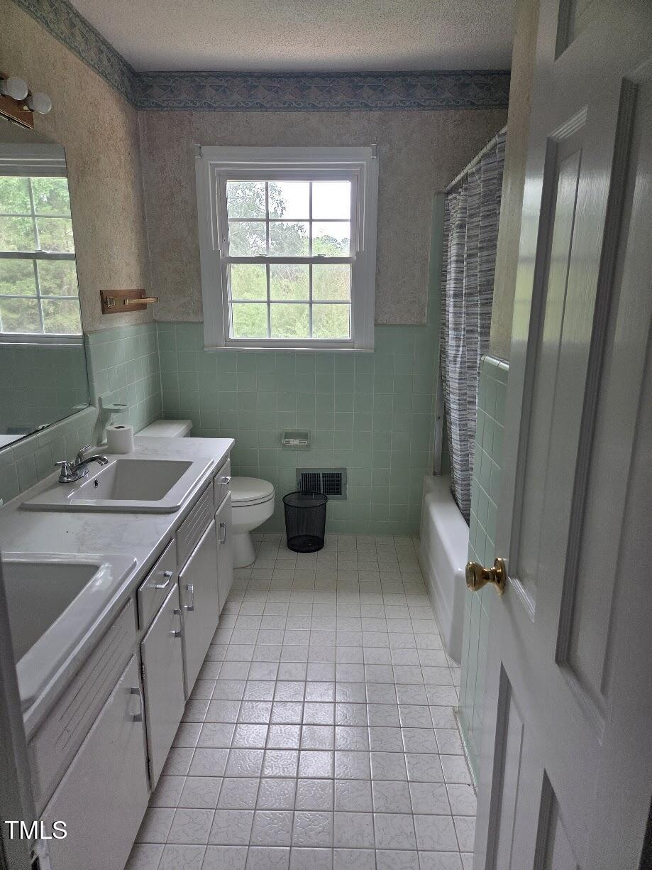 4116 Jane Lane Raleigh, NC 27604 - Photo 7 of 25 a bathroom with a sink a toilet and a mirror