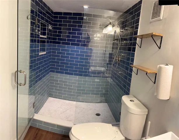 a bathroom with a toilet and shower