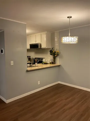 a view of a room with wooden floor and window