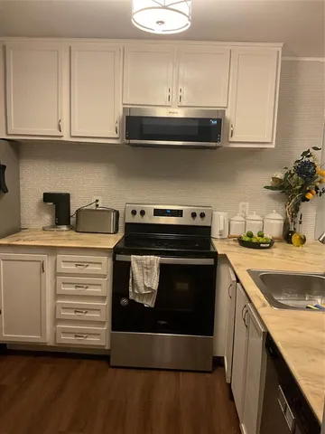 a kitchen with stainless steel appliances granite countertop a sink and cabinets