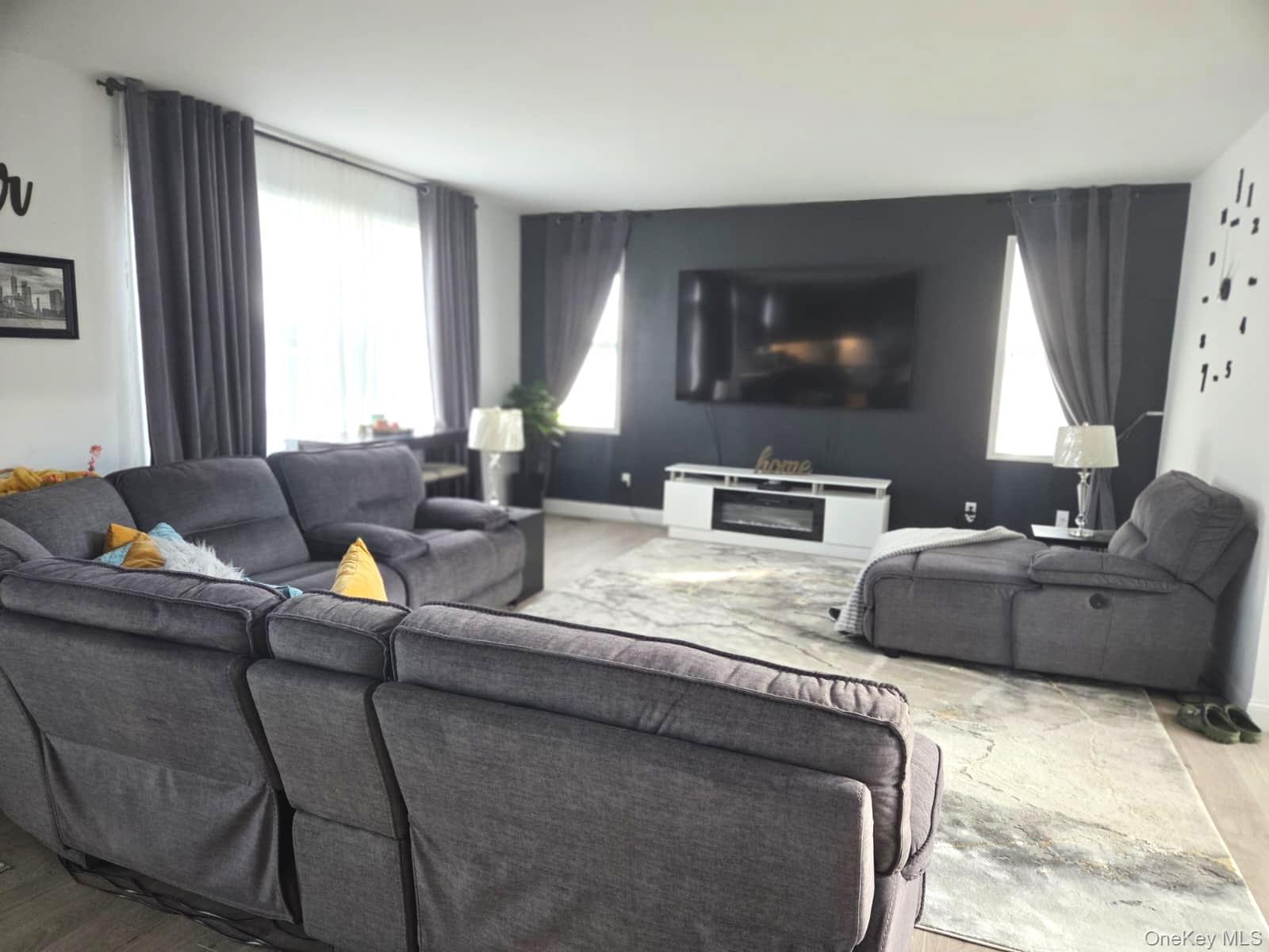 9 Lilac Lane Ridge, NY 11961 - Photo 2 of 9 a living room with furniture and a flat screen tv