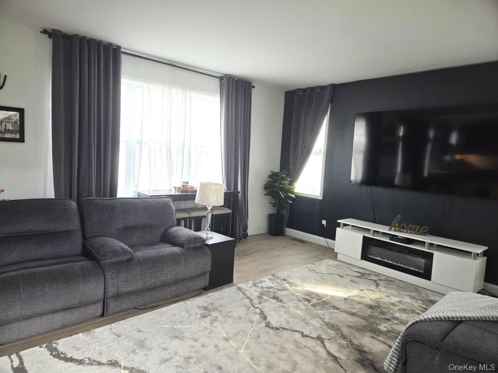 9 Lilac Lane Ridge, NY 11961 - Photo 3 of 9 a living room with furniture and a window