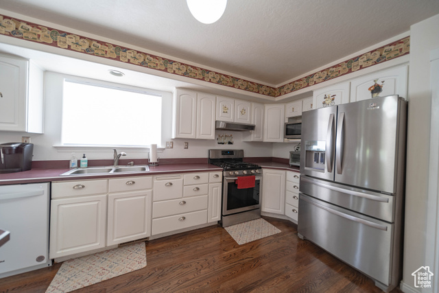 190 600 North Ferron, UT 84523 - Photo 11 of 85 Kitchen featuring appliances - gas 5 burner stove, fridge, dishwasher white cabinets andd wood floors.