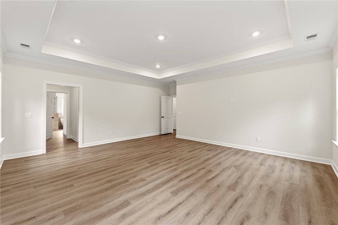 705 Weathered Oak Way Anderson, SC 29621 - Photo 27 of 47 This expansive room features beautiful flooring and elegant ceiling details, offering a versatile living space.