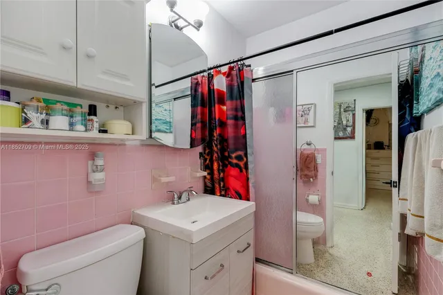 a bathroom with a sink toilet and shower