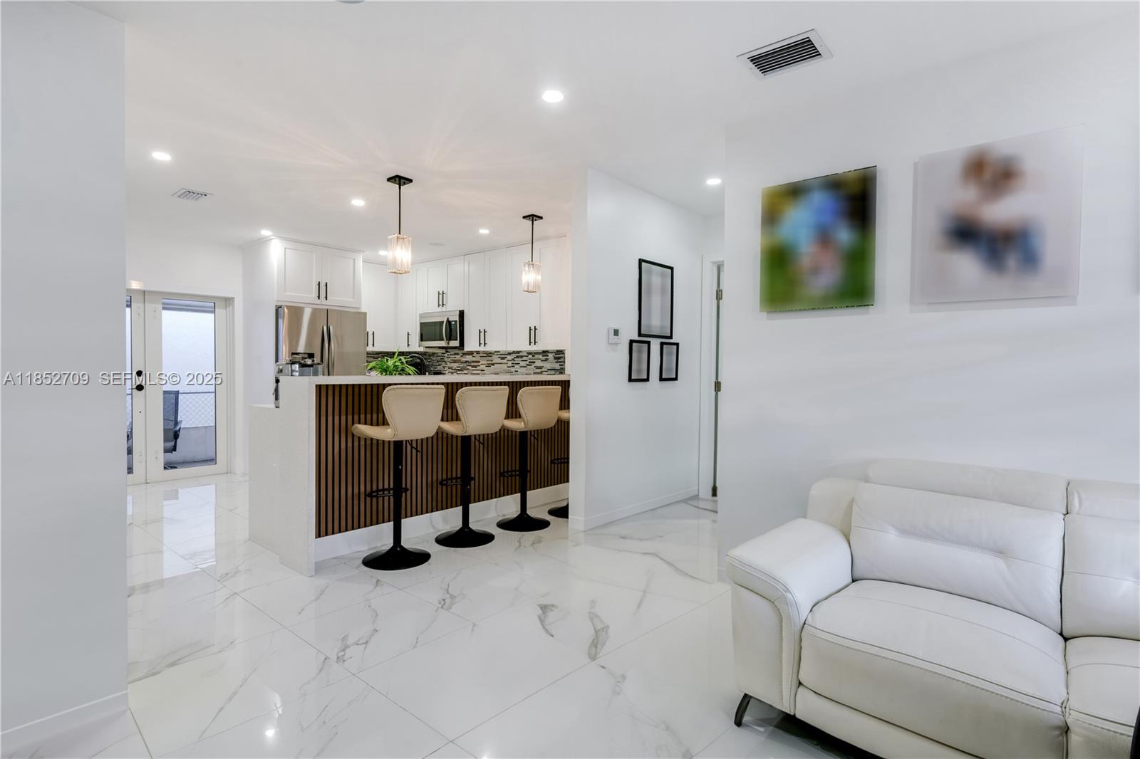 9311 Southwest 37th Street Miami, FL 33165 - Photo 15 of 39 a living room with furniture and a flat screen tv