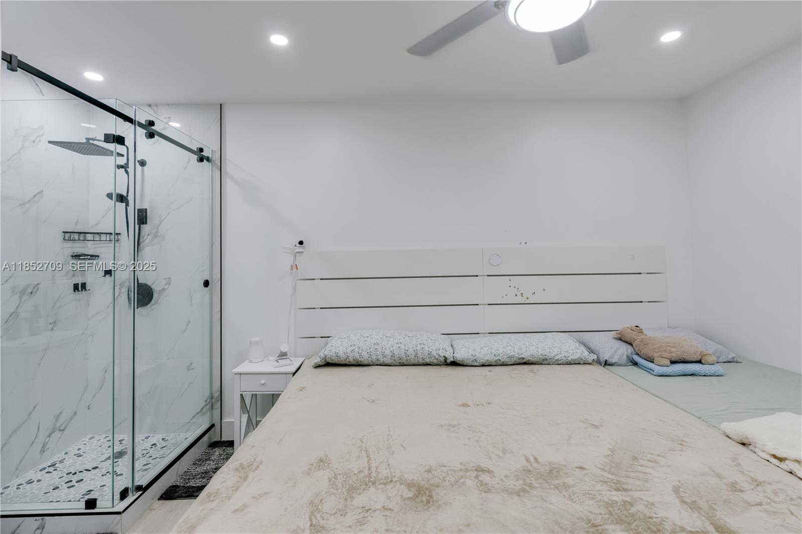 9311 Southwest 37th Street Miami, FL 33165 - Photo 19 of 39 a bedroom with a bed and a shower