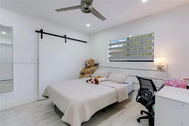 a bed room with a bed and a window