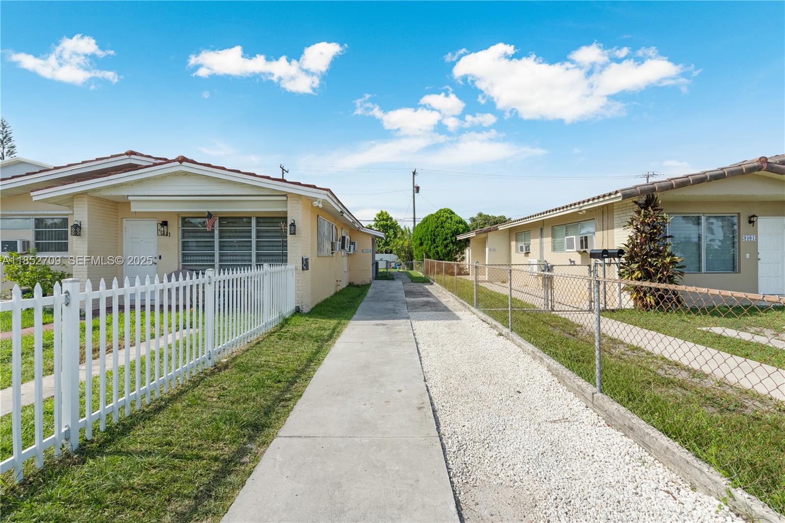 9311 Southwest 37th Street Miami, FL 33165 - Photo 4 of 39 a view of a house with a yard and potted plants