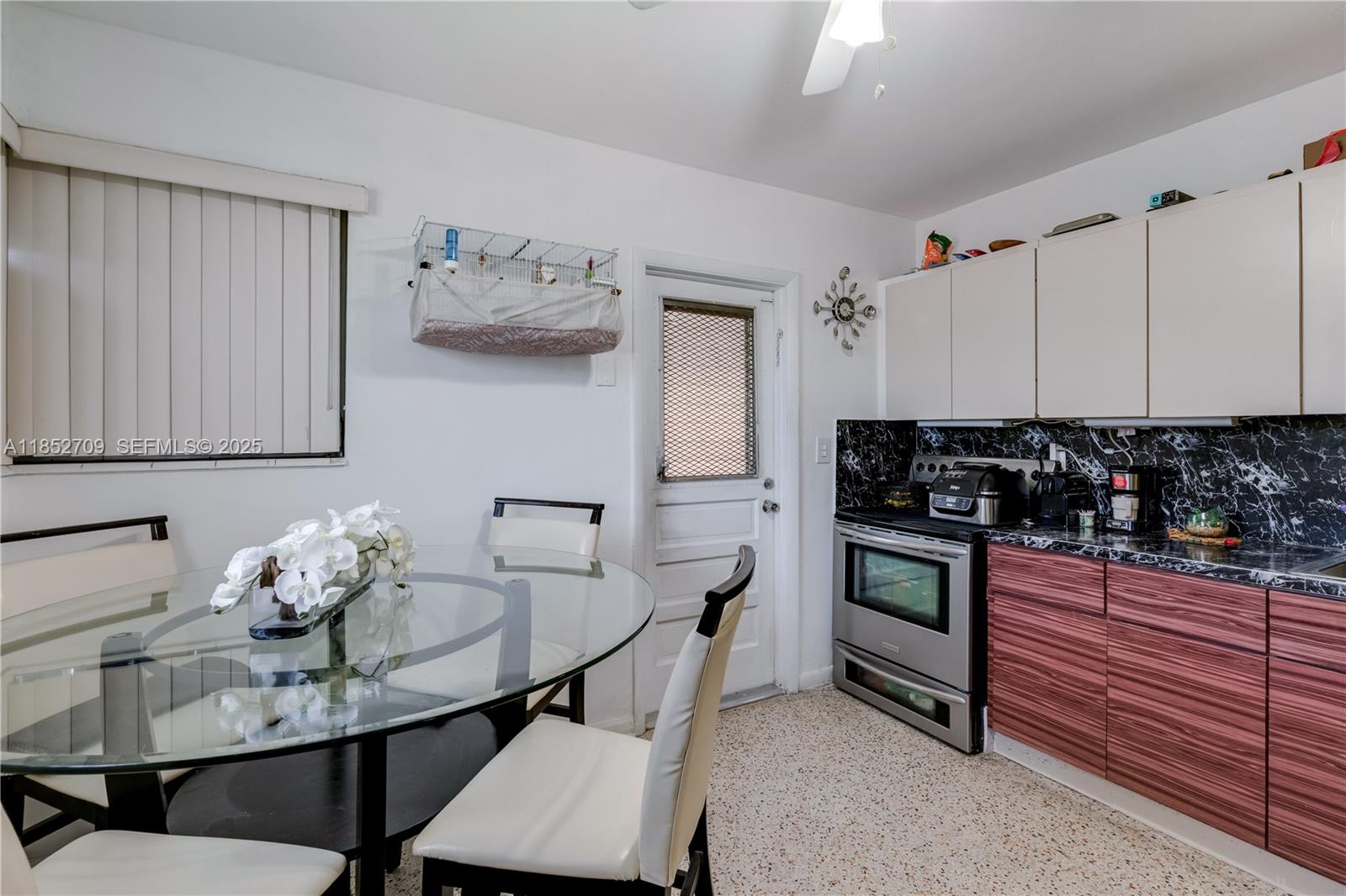 9311 Southwest 37th Street Miami, FL 33165 - Photo 8 of 39 a kitchen with stainless steel appliances kitchen island granite countertop a stove a sink and a refrigerator
