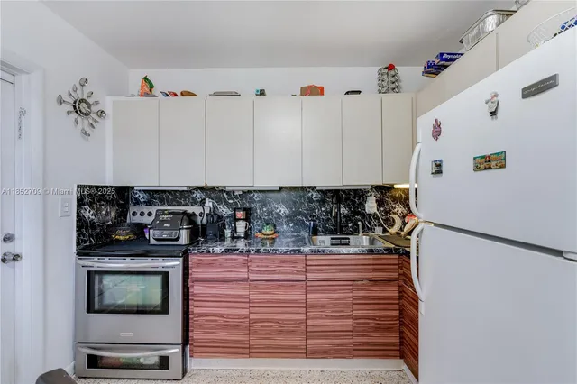 a kitchen with a refrigerator and a stove