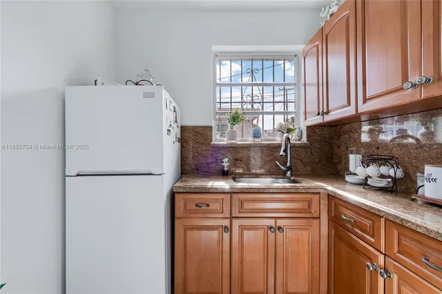 a white refrigerator freezer sitting inside of a kitchen