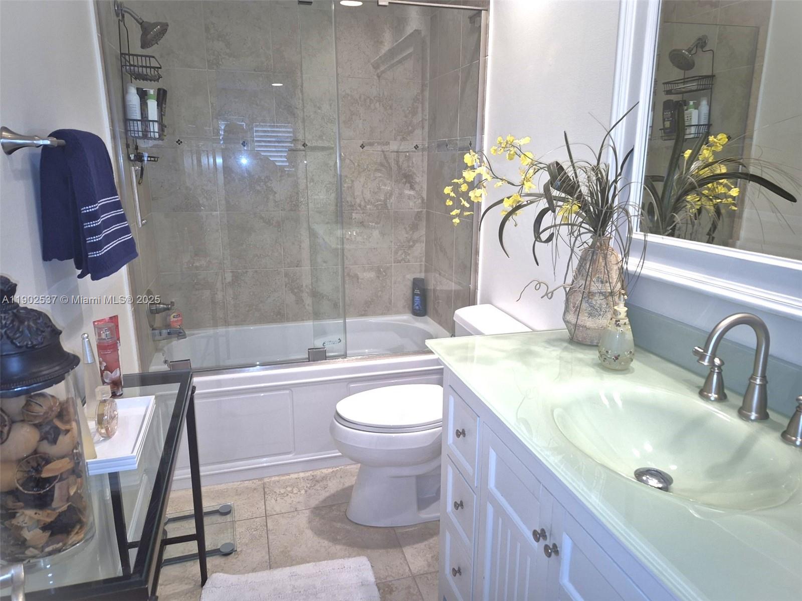 535 Hendricks Isle, Unit 306 Fort Lauderdale, FL 33301 - Photo 13 of 32 a bathroom with a sink a toilet and shower