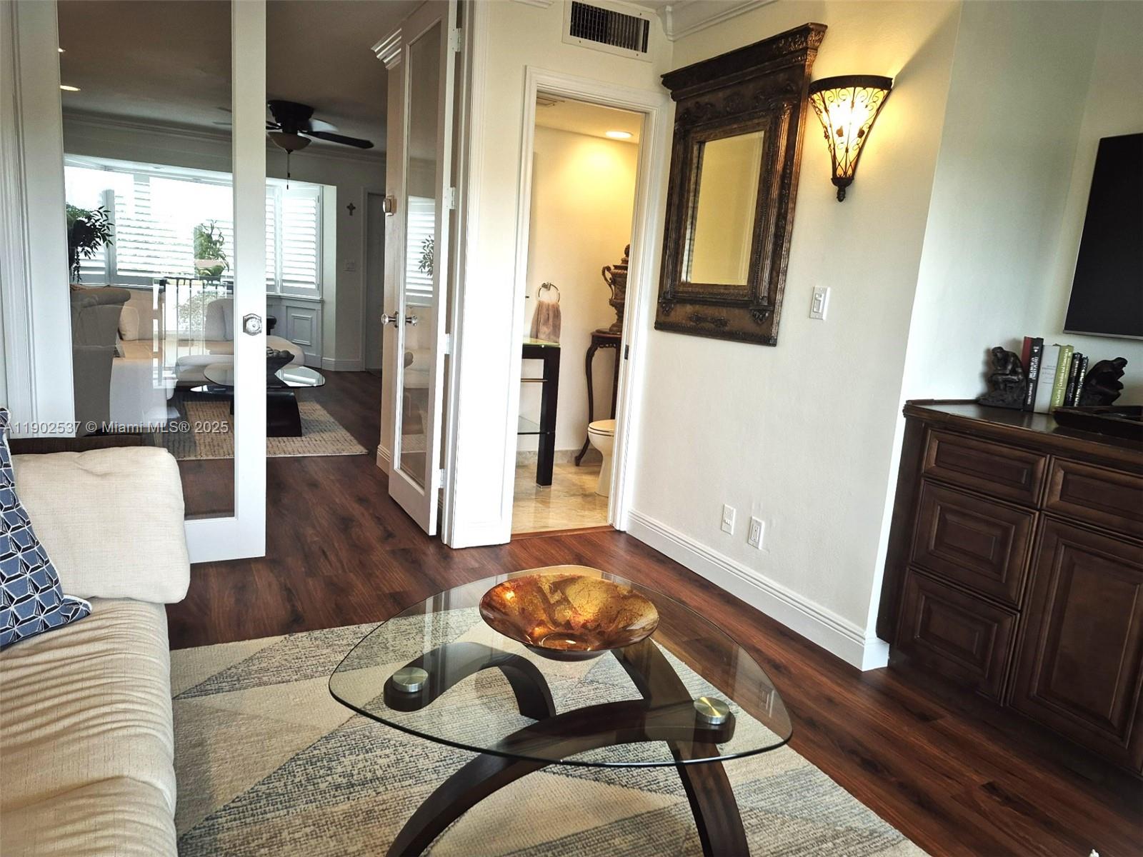 535 Hendricks Isle, Unit 306 Fort Lauderdale, FL 33301 - Photo 15 of 32 a living room with furniture and wooden floor