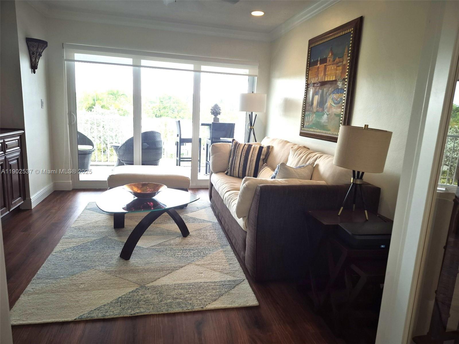 535 Hendricks Isle, Unit 306 Fort Lauderdale, FL 33301 - Photo 17 of 32 a living room with furniture and a wooden floor