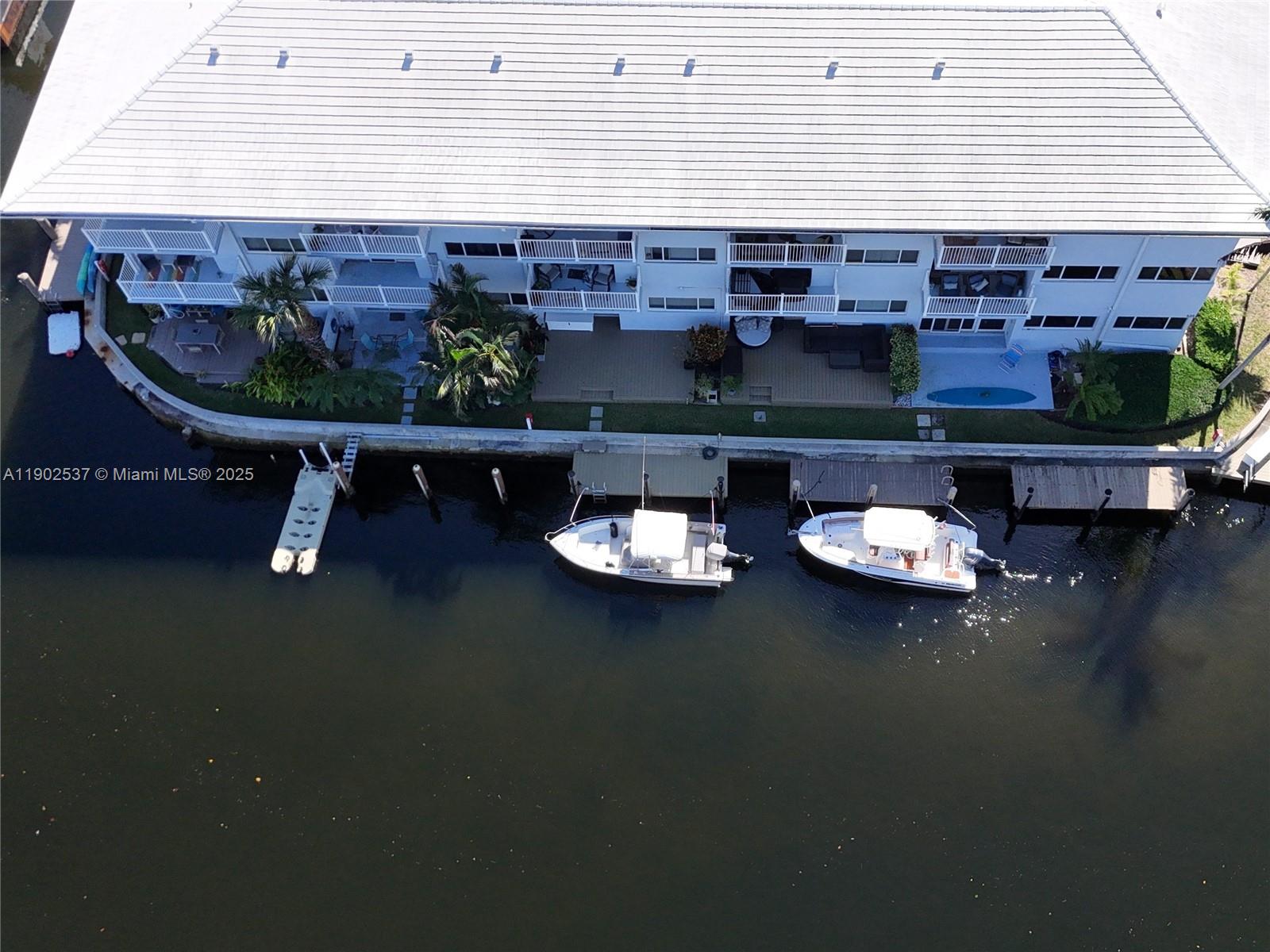 535 Hendricks Isle, Unit 306 Fort Lauderdale, FL 33301 - Photo 28 of 32 a living room with furniture and a fireplace