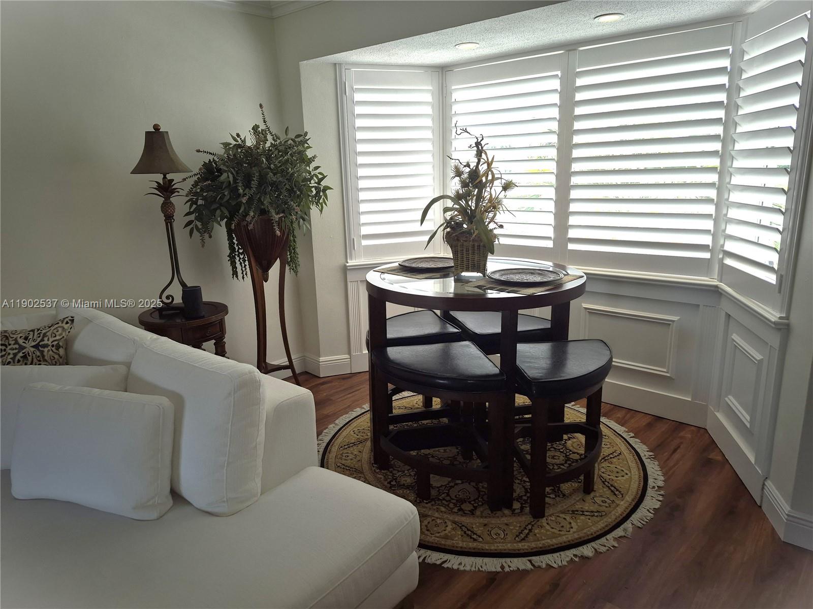 535 Hendricks Isle, Unit 306 Fort Lauderdale, FL 33301 - Photo 4 of 32 a living room with furniture and a potted plant
