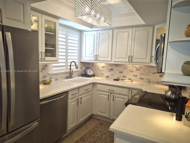 a kitchen with a sink cabinets and appliances