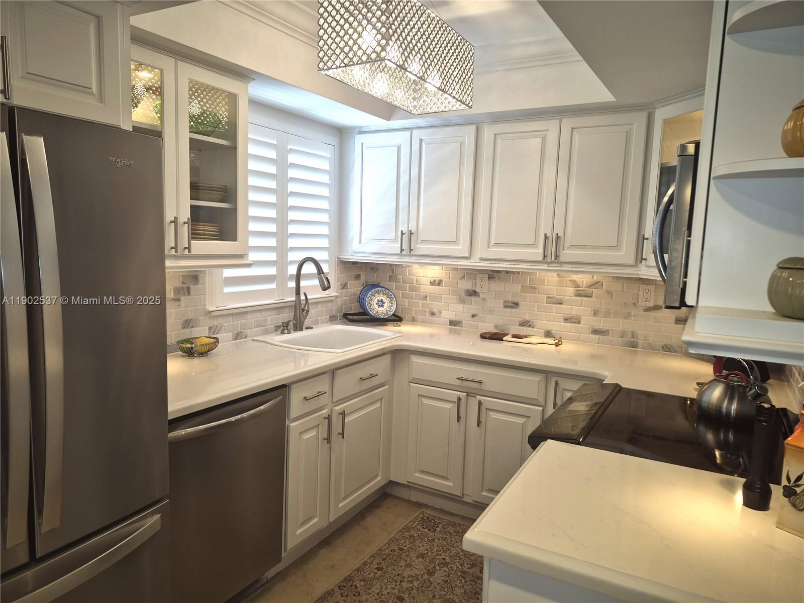 535 Hendricks Isle, Unit 306 Fort Lauderdale, FL 33301 - Photo 9 of 32 a kitchen with a sink cabinets and appliances