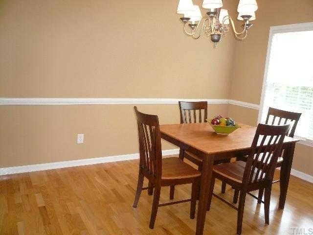 8008 Strawberry Meadows Street Raleigh, NC 27613 - Photo 3 of 12 The formla dining room is spacious with laminate hardwood floors, chair rail, crown molding, fresh paint and a new brushed nickel chandelier.